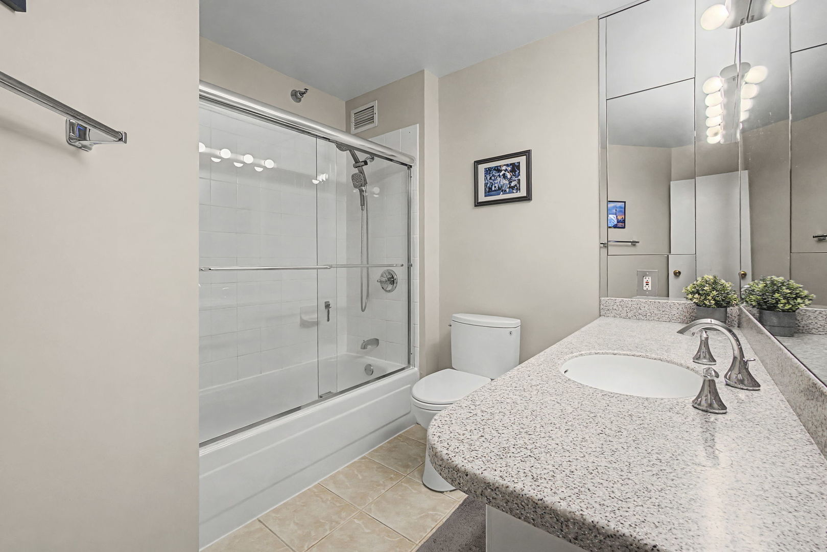 401 East Ontario Street, Unit 3102 Chicago, IL 60611 - Photo 20 of 29 a bathroom with a granite countertop sink a toilet and shower
