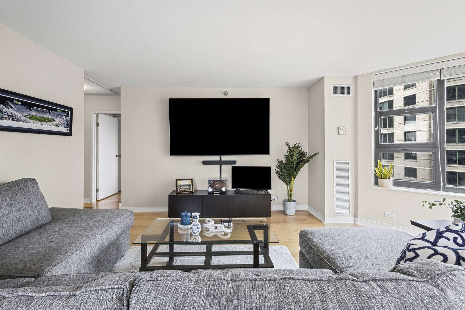 401 East Ontario Street, Unit 3102 Chicago, IL 60611 - Photo 5 of 29 a living room with furniture and a flat screen tv