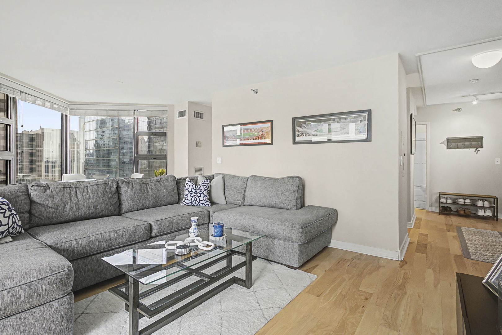 401 East Ontario Street, Unit 3102 Chicago, IL 60611 - Photo 6 of 29 a living room with furniture a large window and a flat screen tv