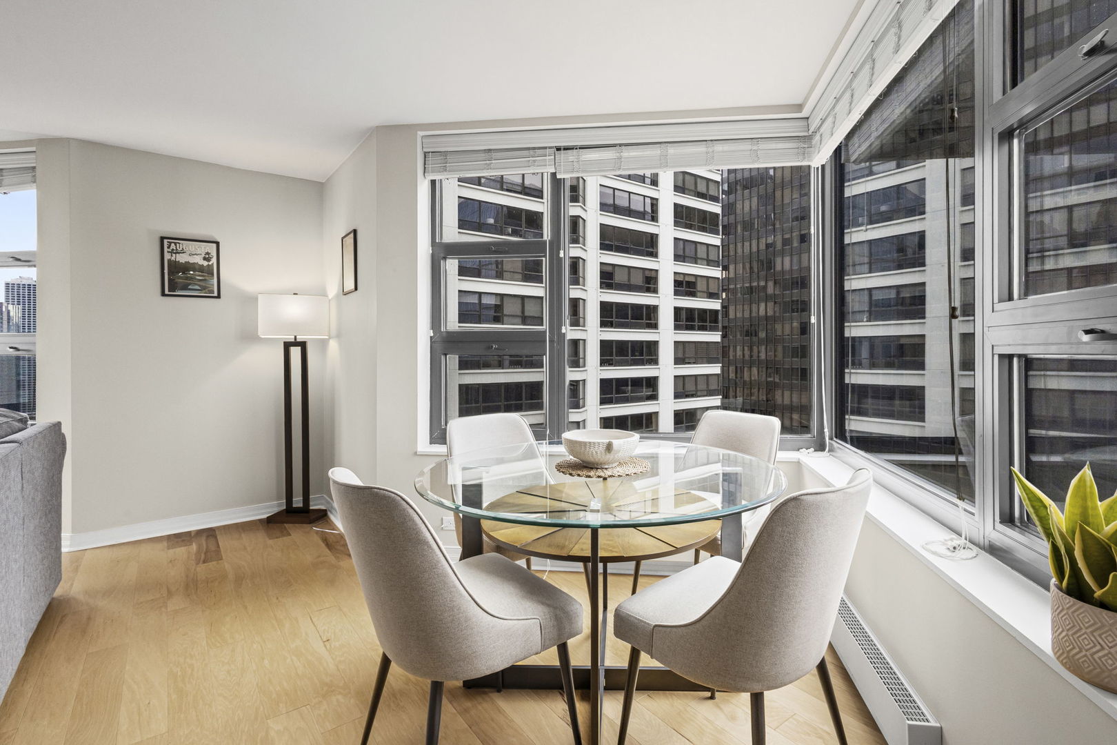 401 East Ontario Street, Unit 3102 Chicago, IL 60611 - Photo 9 of 29 a dining room with furniture and a floor to ceiling window