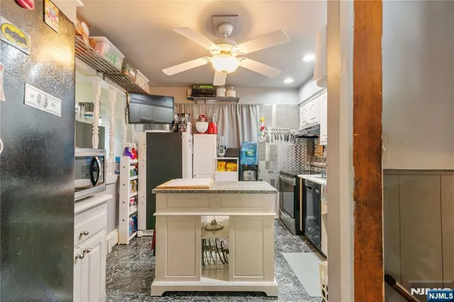 a kitchen with stainless steel appliances granite countertop sink stove and refrigerator