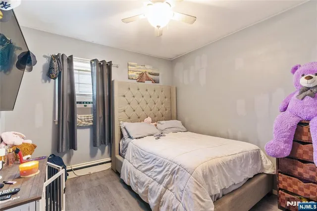 a bedroom with a bed closet and a window