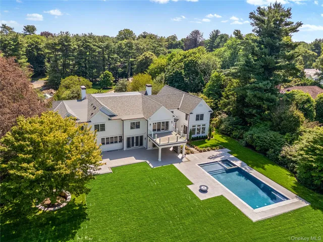 an aerial view of a house with swimming pool garden and patio
