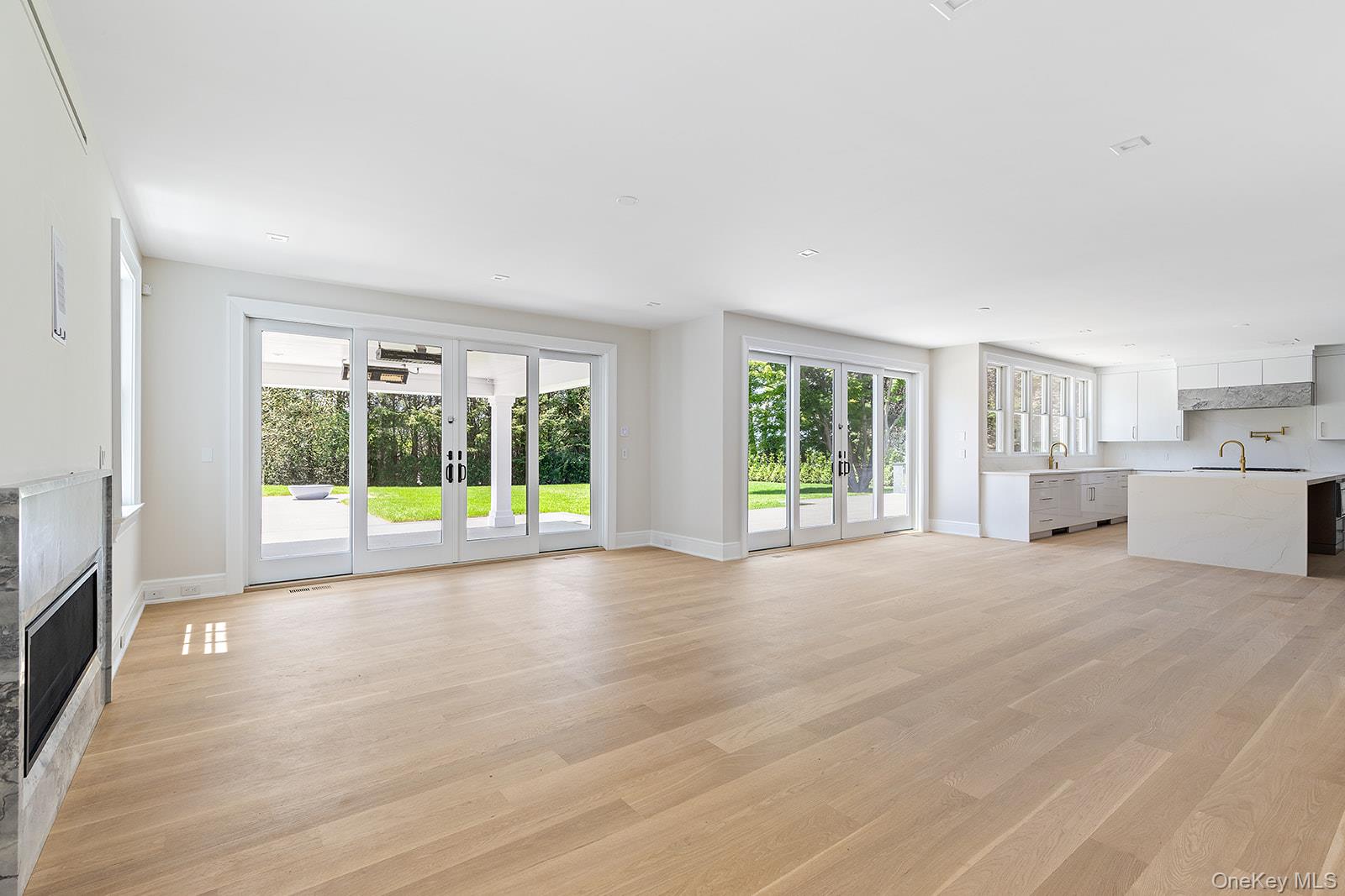 42 Mamaroneck Road Scarsdale, NY 10583 - Photo 19 of 49 View of the open concept layout showcases the family room, breakfast area and kitchen. Walls of glass and multiple glass doors open to the expansive patio, covered porch, outdoor kitchen, pool and property.