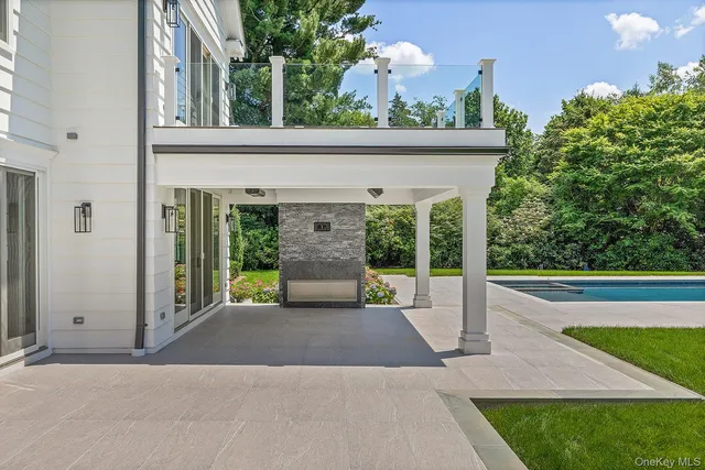 a view of a house with a bench and a garden
