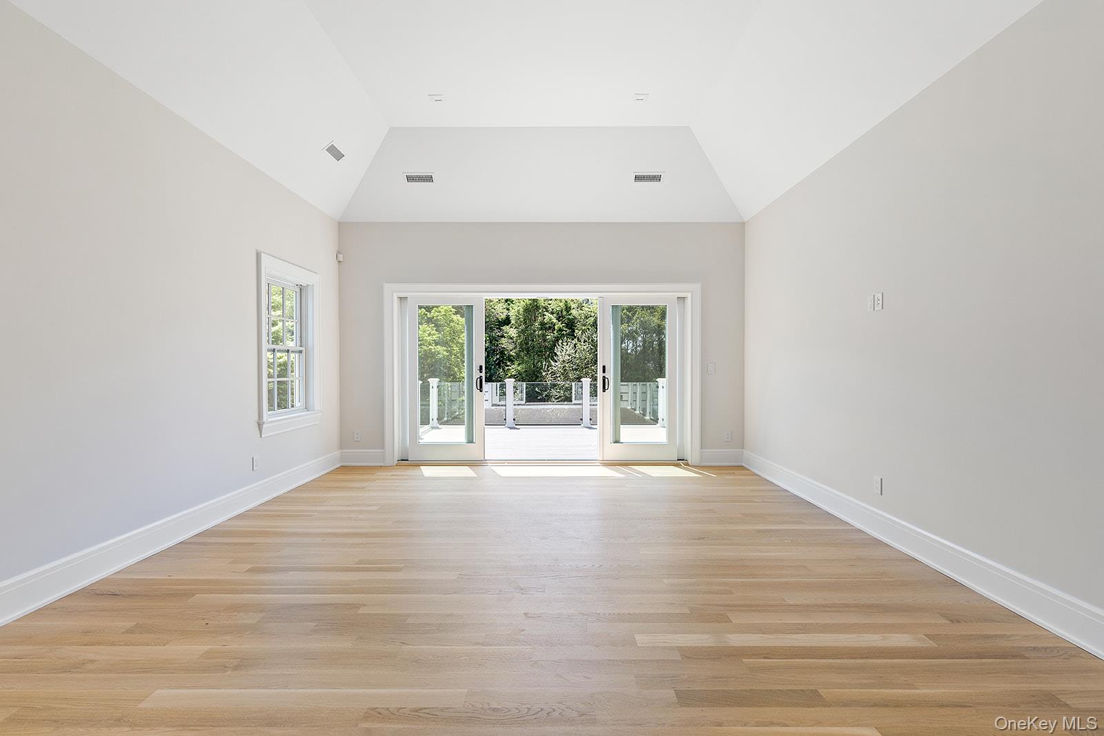 42 Mamaroneck Road Scarsdale, NY 10583 - Photo 32 of 49 Primary bedroom suite with vaulted tray ceiling, expansive roof deck with property views, a wet bar, separate sitting room/office and two custom-fitted walk-in closets.