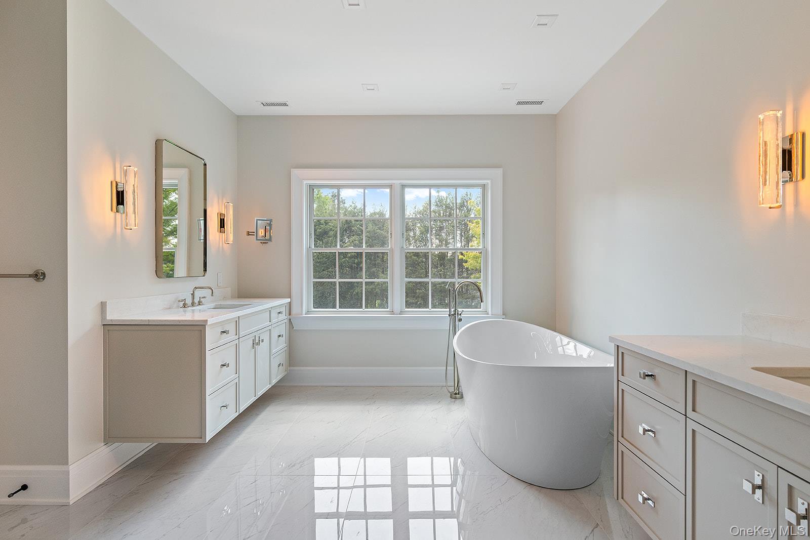 42 Mamaroneck Road Scarsdale, NY 10583 - Photo 34 of 49 Luxurious primary bathroom with two vanities, floating soaking tub, separate oversized shower, and water closet.