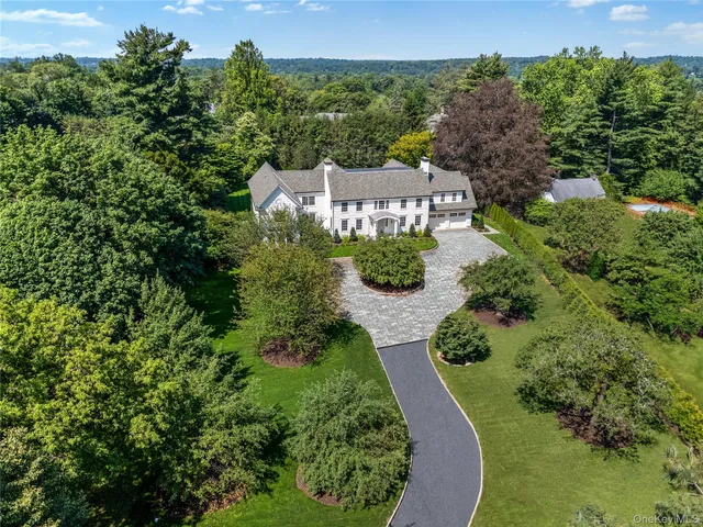 an aerial view of a house with swimming pool and garden