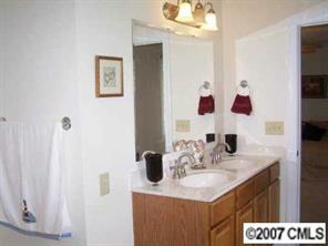 2318 Goldmine Road Monroe, NC 28110 - Photo 6 of 8 a bathroom with a sink and a mirror