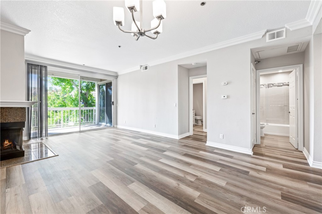 20301 Bluffside Circle, Unit 304 Huntington Beach, CA 92646 - Photo 15 of 36 a view of a livingroom with wooden floor and a fireplace