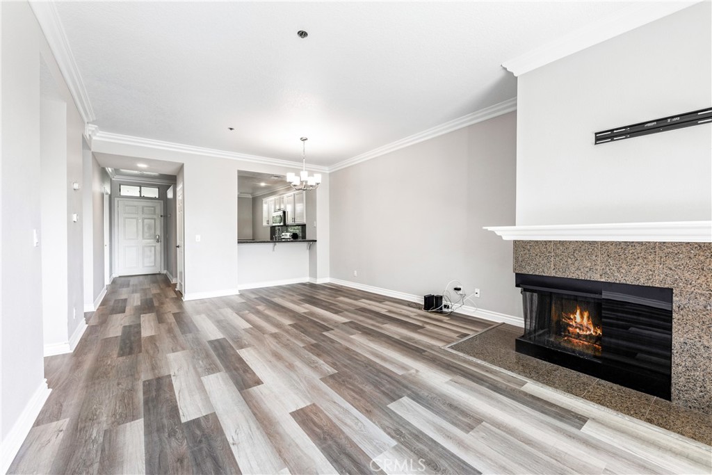 20301 Bluffside Circle, Unit 304 Huntington Beach, CA 92646 - Photo 18 of 36 a view of empty room with wooden floor and fireplace