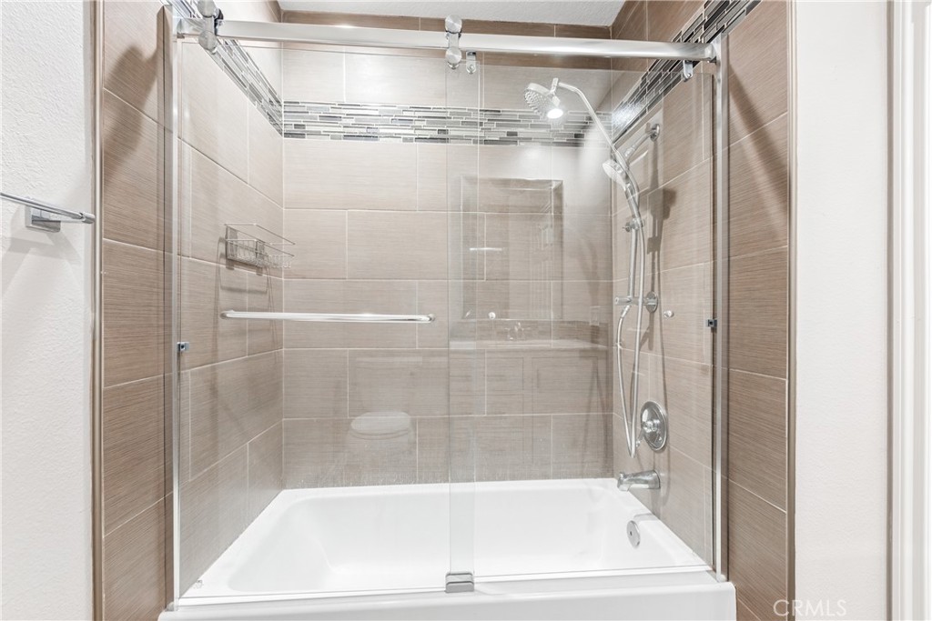 20301 Bluffside Circle, Unit 304 Huntington Beach, CA 92646 - Photo 27 of 36 a bathroom with a shower and a bath tub
