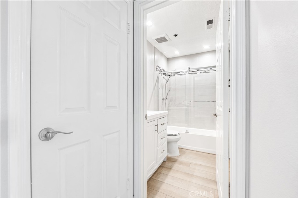 20301 Bluffside Circle, Unit 304 Huntington Beach, CA 92646 - Photo 34 of 36 a bathroom with a double vanity sink toilet and shower