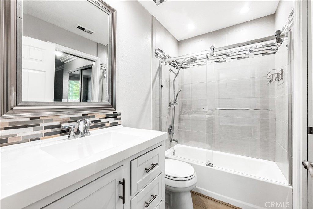 20301 Bluffside Circle, Unit 304 Huntington Beach, CA 92646 - Photo 35 of 36 a bathroom with a sink mirror toilet and bathtub
