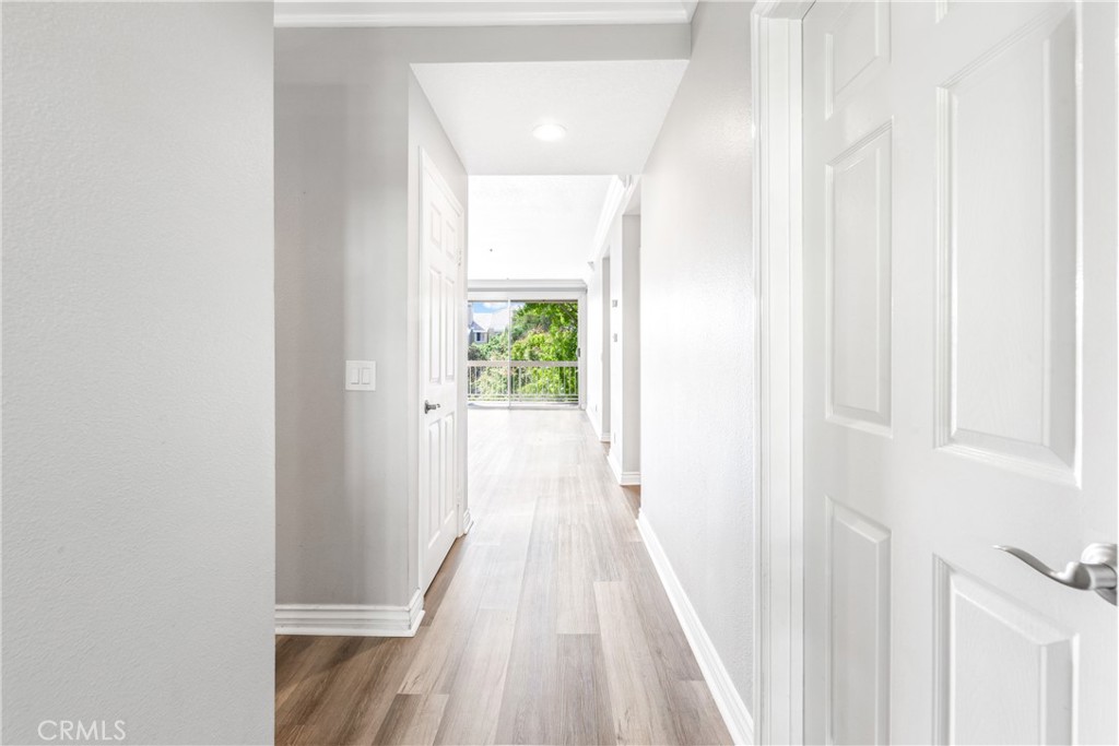 20301 Bluffside Circle, Unit 304 Huntington Beach, CA 92646 - Photo 4 of 36 a view of a hallway with wooden floor