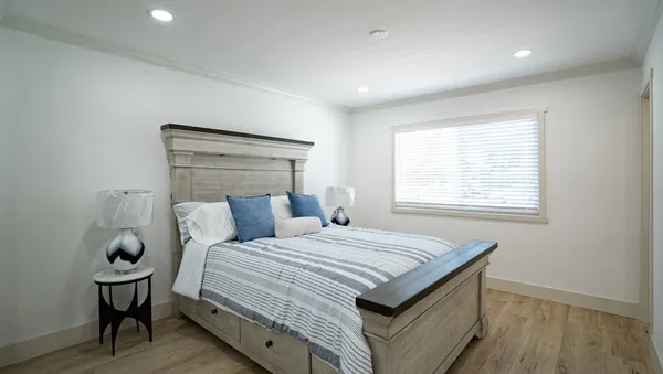 a bedroom with a bed and window