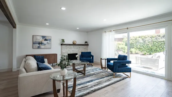 a living room with fireplace furniture and a large window