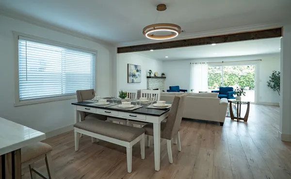 a view of a dining room with furniture and wooden floor