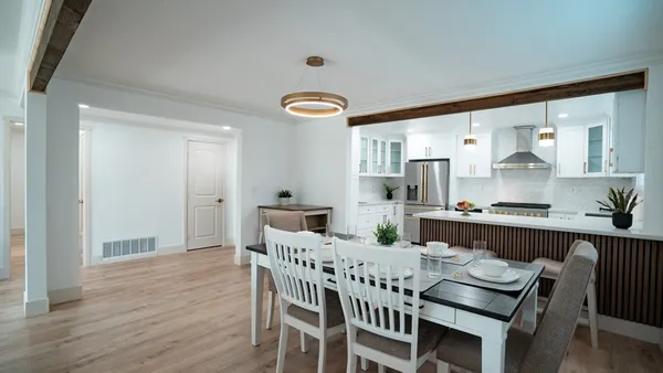 a view of a dining room with furniture and wooden floor