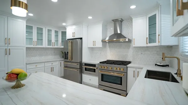 a kitchen with stainless steel appliances a stove a sink and a refrigerator