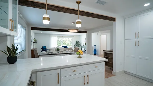 a view of a center island and chandelier in a kitchen