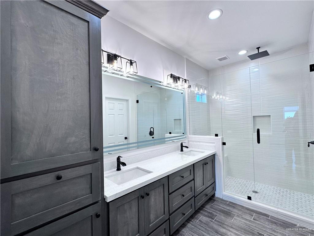 1100 Azalea Street Mission, TX 78573 - Photo 15 of 24 a spacious bathroom with a shower sink and mirror
