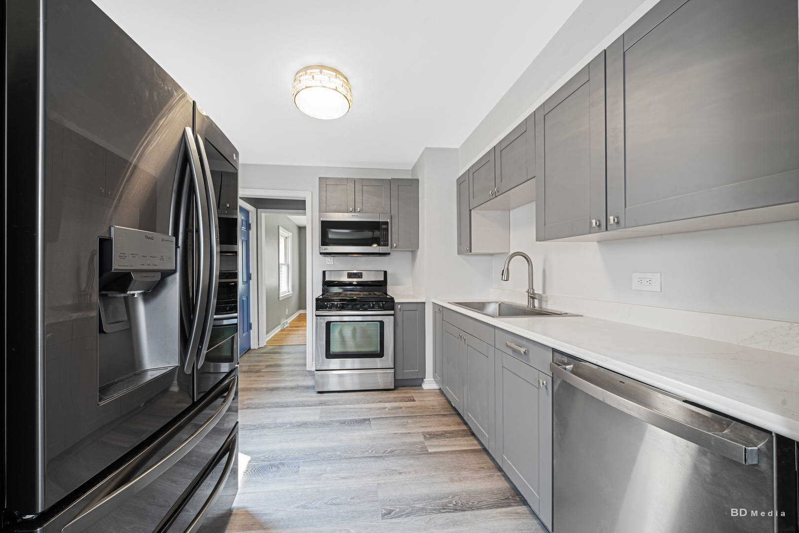 446 Warren Street Calumet City, IL 60409 - Photo 4 of 20 a kitchen with stainless steel appliances a refrigerator and a sink