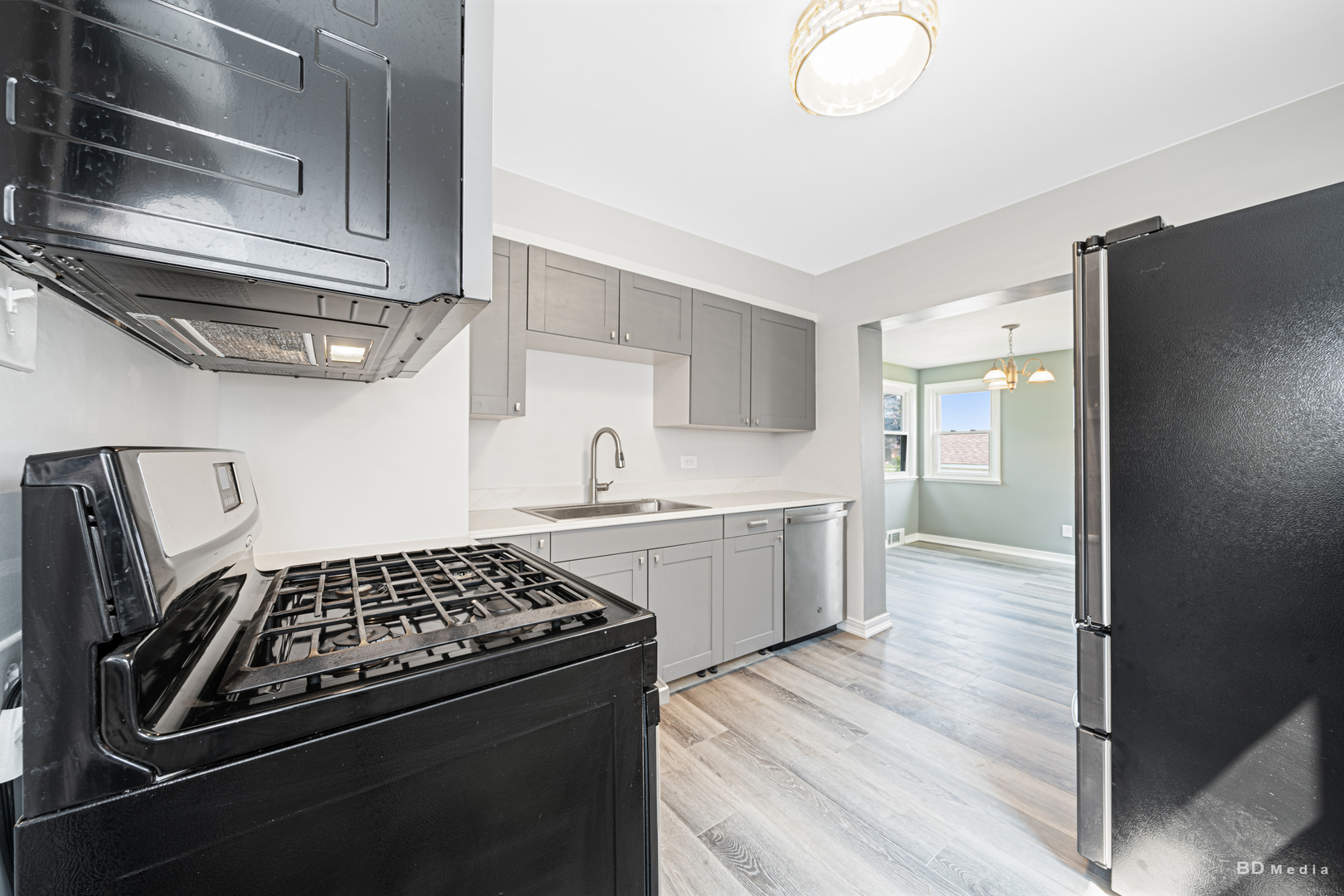 446 Warren Street Calumet City, IL 60409 - Photo 5 of 20 a kitchen with stainless steel appliances a sink a stove and cabinets