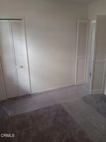 a view of a hallway with wooden shelves