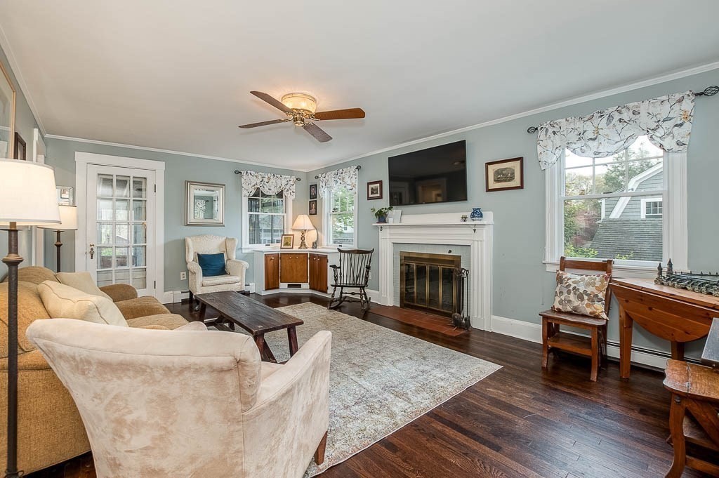 64 Prospect Street Needham, MA 02492 - Photo 8 of 34 a living room with furniture a fireplace and a flat screen tv