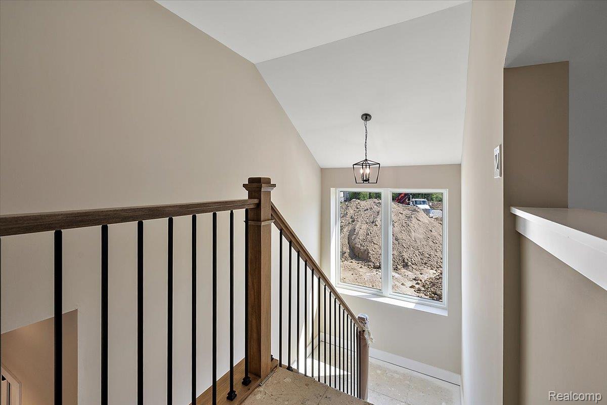 2032 Breckenridge Court, Unit 9 Rochester, MI 48309 - Photo 32 of 39 Staircase featuring lofted ceiling and baseboards