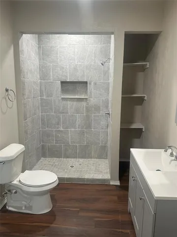 a bathroom with a toilet a sink and shower