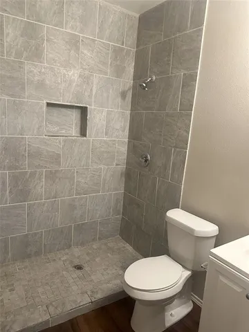 a white toilet sitting next to a bathroom sink
