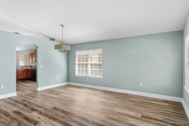 a large kitchen with granite countertop a sink stainless steel appliances and cabinets