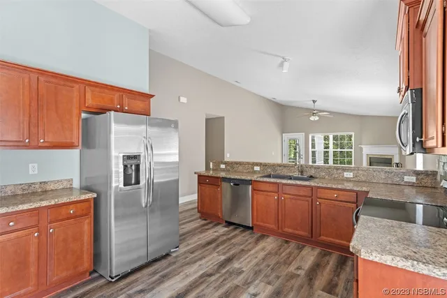 a kitchen with stainless steel appliances granite countertop a sink stove and cabinets