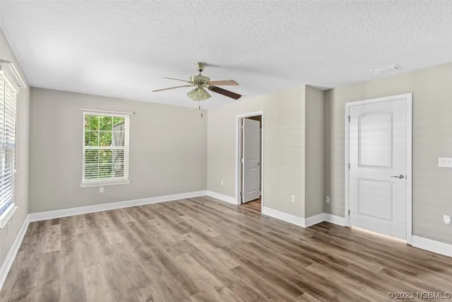 a view of a room with wooden floor and bathroom