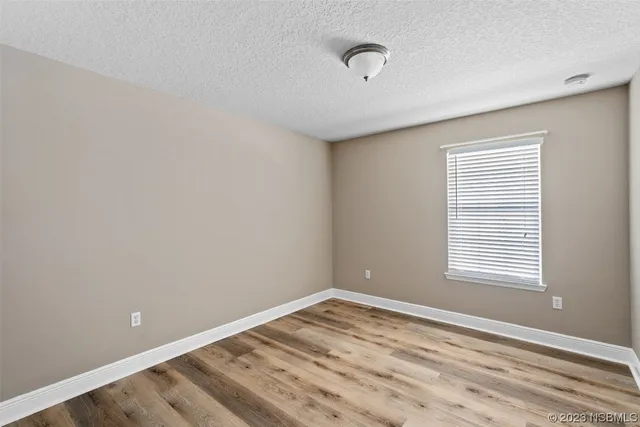 a bathroom with a granite countertop toilet a sink and a mirror