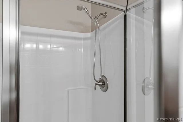 a bathroom with a sink toilet double vanity and shower