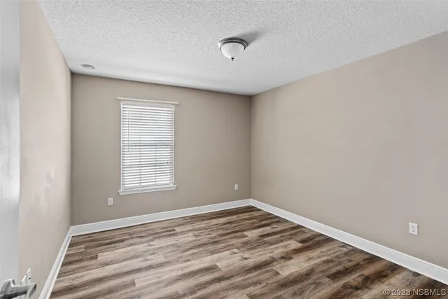 a view of house with swimming pool and sitting area