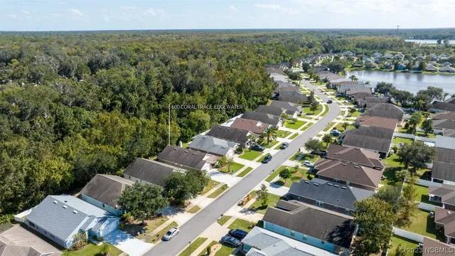 an aerial view of a city with lots of residential buildings and mountain view in back