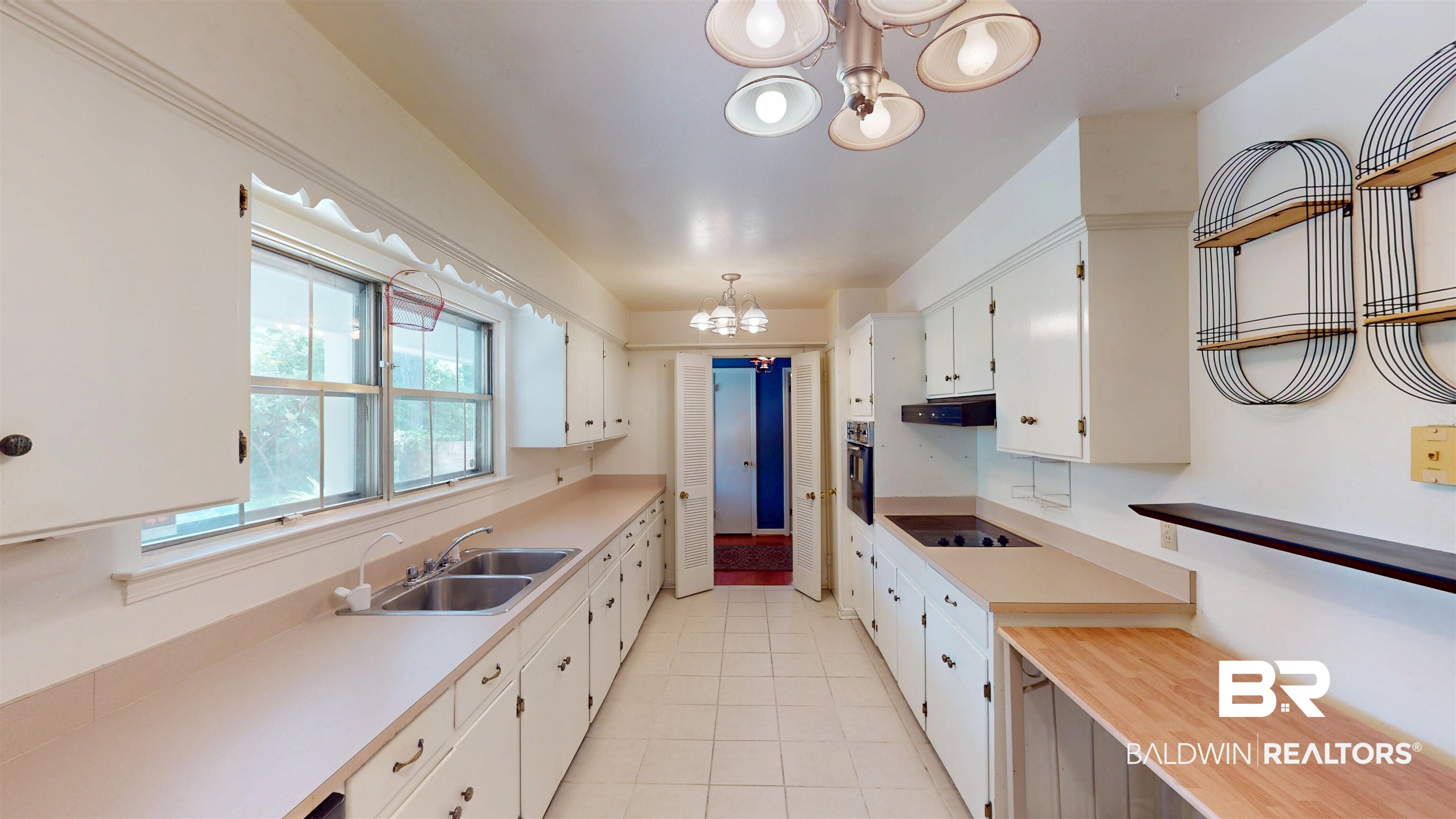 1075 Zurich Street Mobile, AL 36608 - Photo 15 of 35 Kitchen featuring suspended lighting, light countertops, white cabinetry, and oven