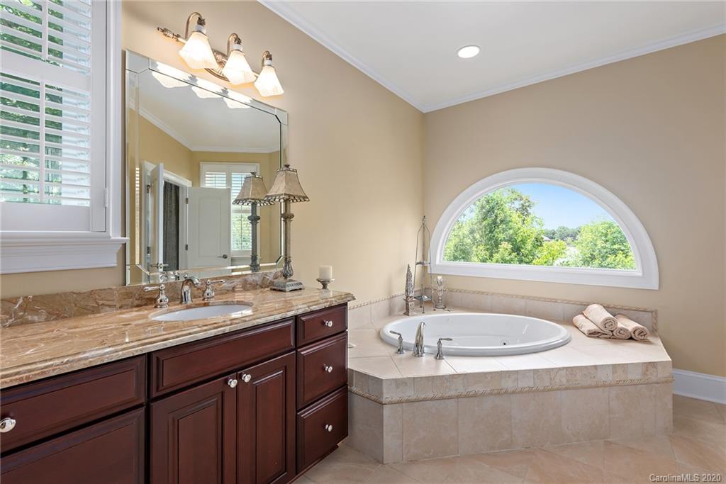 20124 Bascom Ridge Drive Cornelius, NC 28031 - Photo 10 of 40 a bathroom with a granite countertop sink and a large mirror