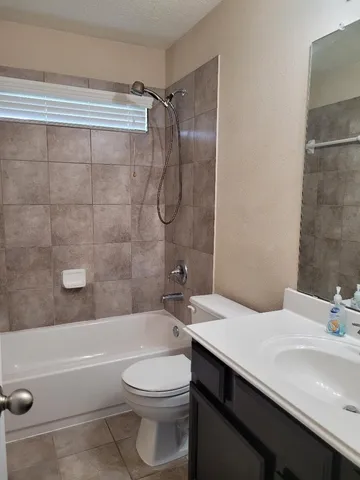 a bathroom with a sink a toilet and bathtub