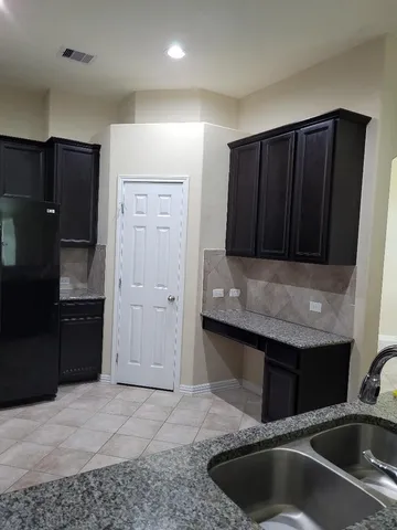 a kitchen with a sink and cabinets