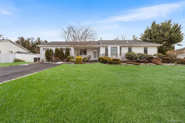 a view of a house with a yard and sitting area
