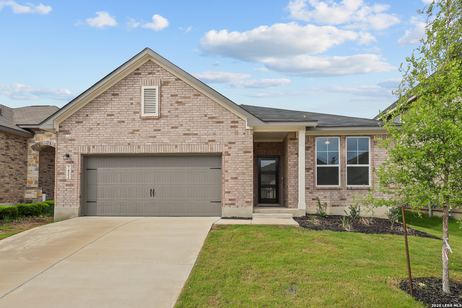 a front view of a house with a yard