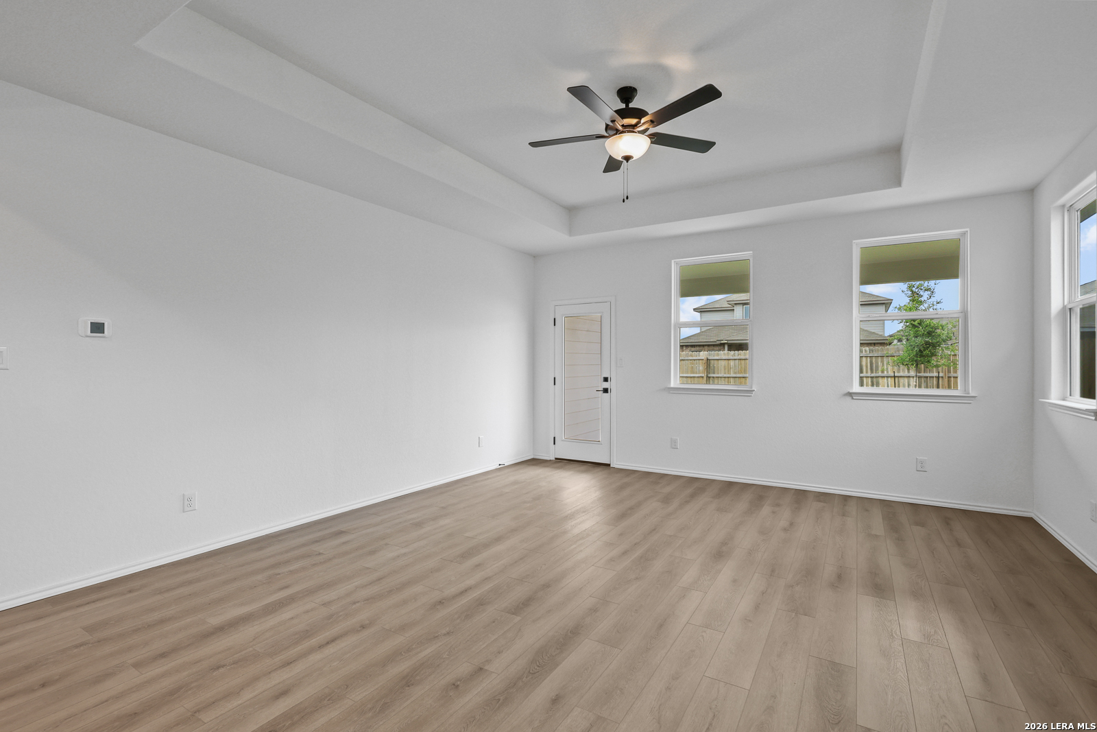 7432 Cremorne Converse, TX 78109 - Photo 16 of 35 a view of an empty room with wooden floor and a window