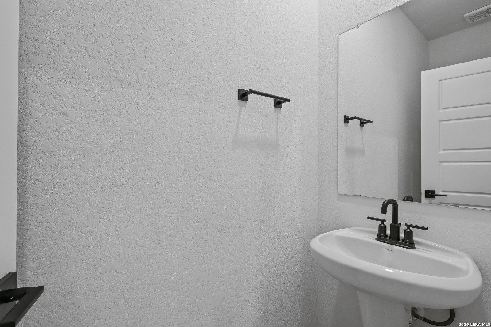 7432 Cremorne Converse, TX 78109 - Photo 29 of 35 a bathroom with a sink and a mirror