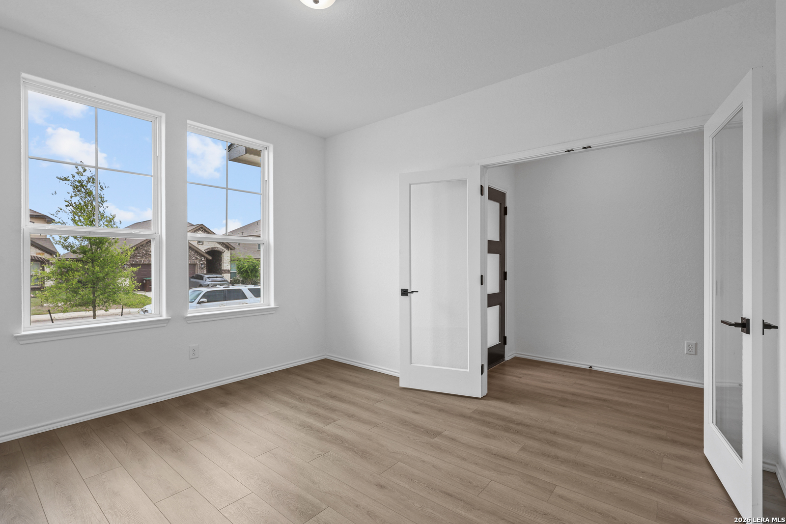 7432 Cremorne Converse, TX 78109 - Photo 6 of 35 a view of an empty room with wooden floor and a window