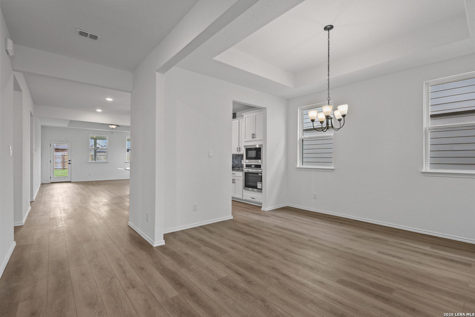 7432 Cremorne Converse, TX 78109 - Photo 7 of 35 a view of empty room with wooden floor and kitchen